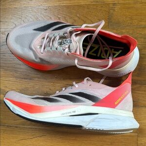 adidas adizero Boston 12 Women's Athletic Shoes - Pink and Black.